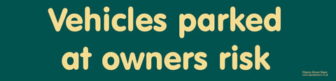 'Vehicles parked at owners risk' sign